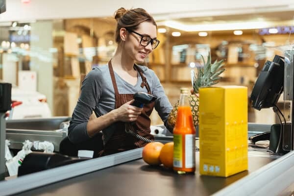 Retail employee scanning items Retail employee scanning items